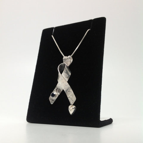 Cancer Ribbon with a Blue Saphire